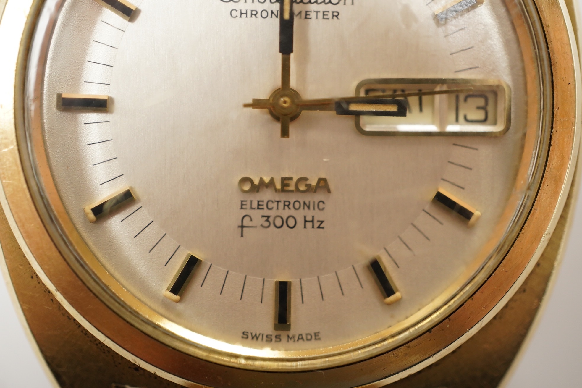 A gentleman's steel and gold plated Omega Constellation Electronic wrist watch, with baton numerals and day/date aperture, case diameter 38mm, on an associated gold plated strap. Condition - poor